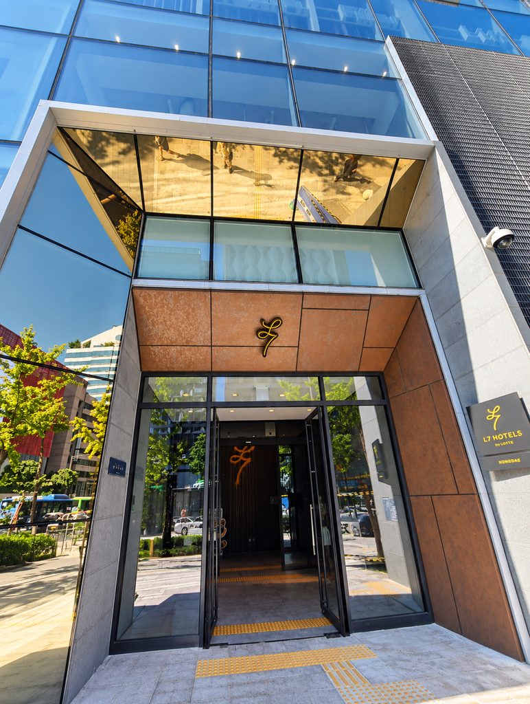 Where to Stay in Seoul: Best Areas for First-Time Visitors Entrance to L7 Hongdae hotel with glass doors and hotel signage