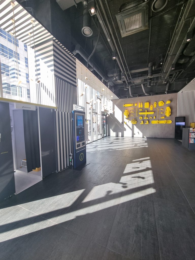 Where to Stay in Seoul: Best Areas for First-Time Visitors L7 Myeongdong hotel lobby with floor-to-ceiling windows and yellow wall art