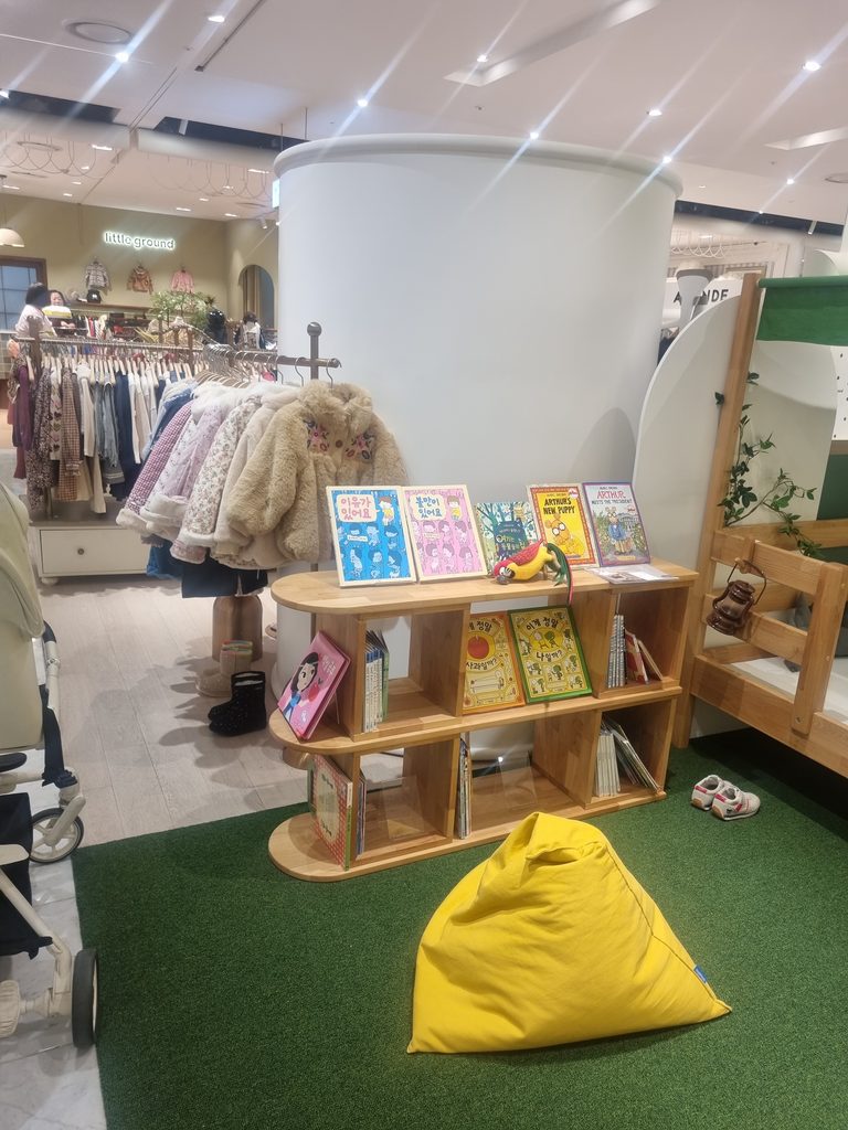 Children's books, seating and retail displays at Hyundai Department Store Trade Center