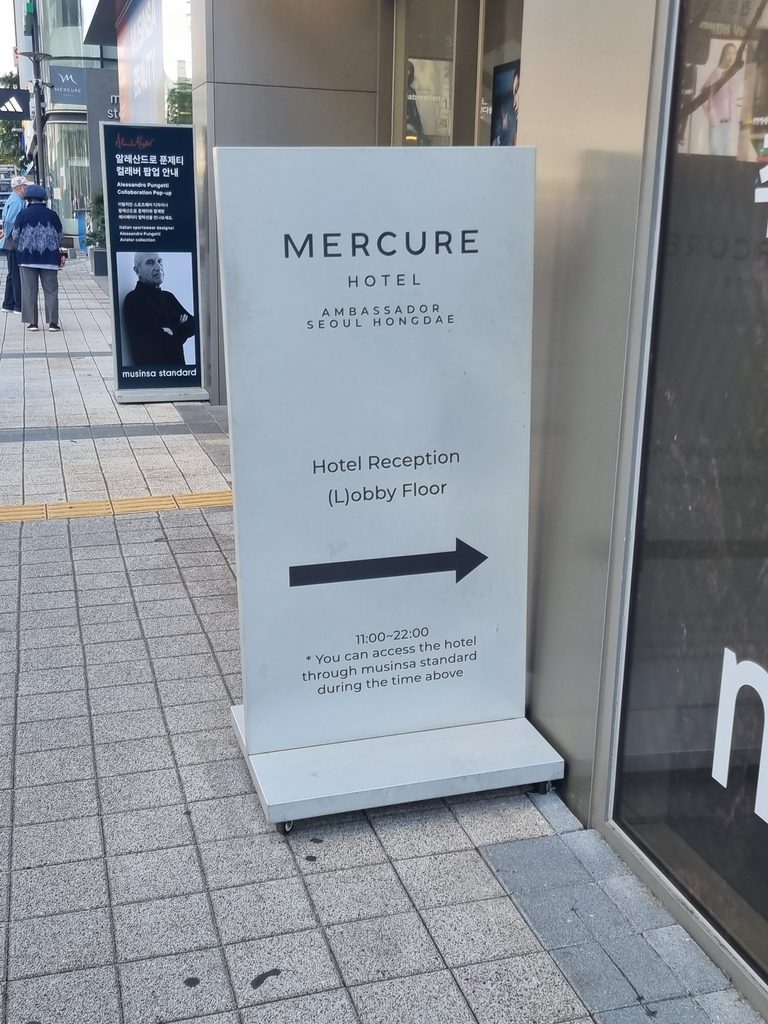 Mercure Ambassador Seoul Hongdae entrance sign with lobby directions